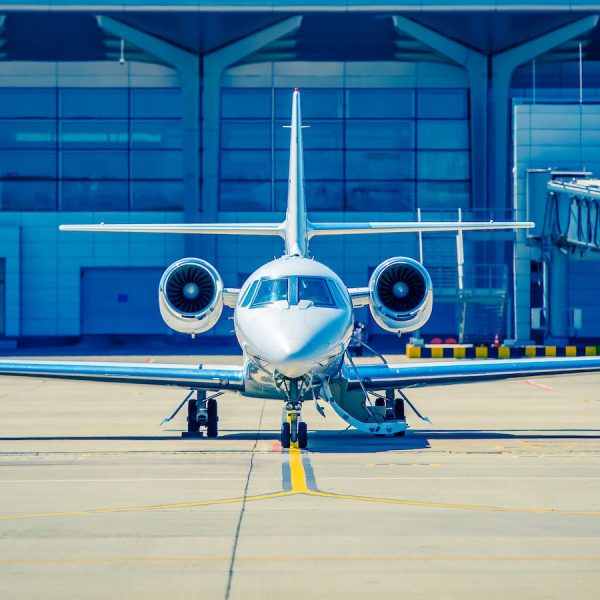 Silver shiny airplane at runway