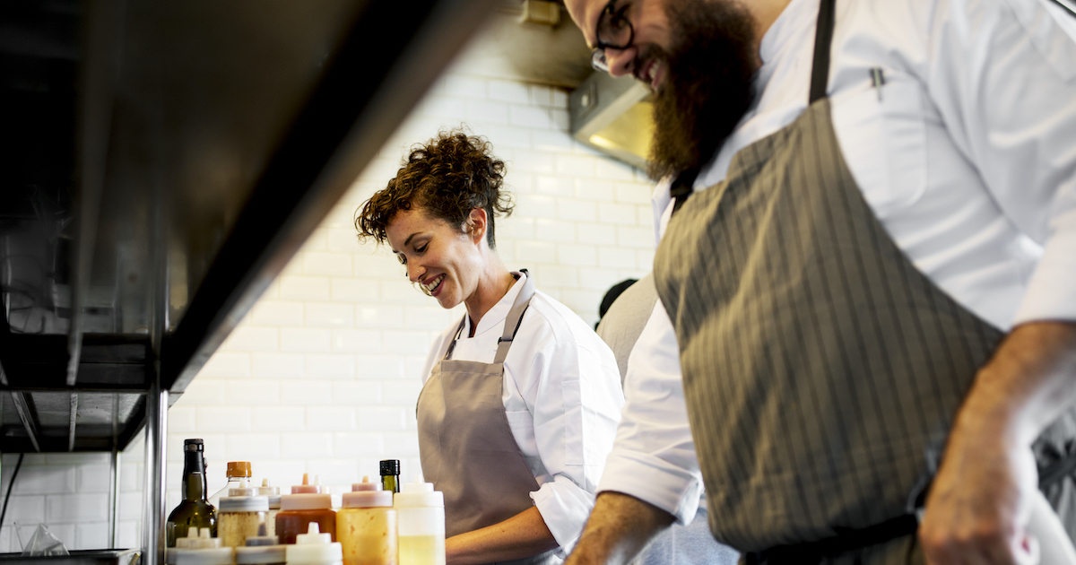 Closeup of kitchen staff prepare cooking ingredients