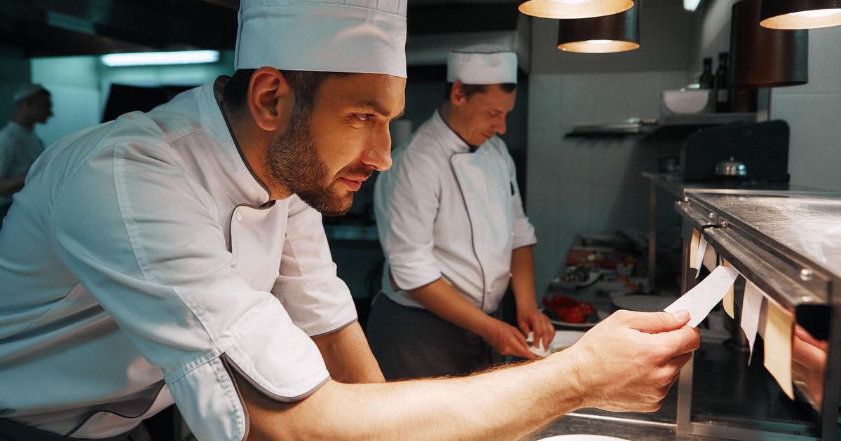 Amazing Service. Chef cook checking the order at the restaurant kitchen