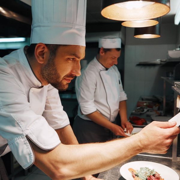 Amazing Service. Chef cook checking the order at the restaurant kitchen