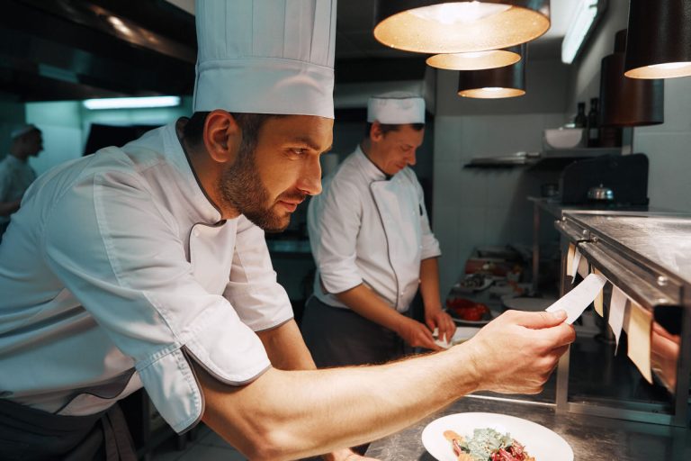 Amazing Service. Chef cook checking the order at the restaurant kitchen